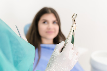 Dentist holding tongs for removing teeth