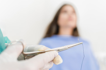 Dentist with sewing tools