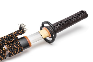 Brown leather cord tie on grip Japanese sword steel fitting and black  scabbard on white background.