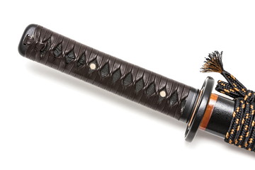 Tsuka: Handle of Japanese sword  isolated in white background. Black rayskin and brown leather cord...