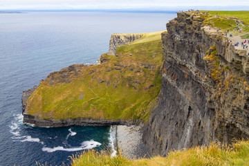 People walking over Cliffs of Moher