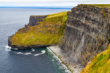 People walking over Cliffs of Moher