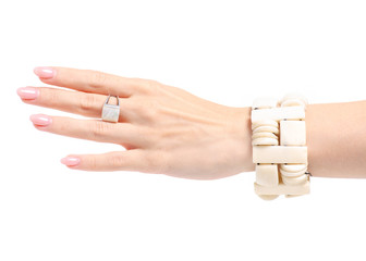 Bijouterie ring bracelet ivory stone in hand on white background isolation