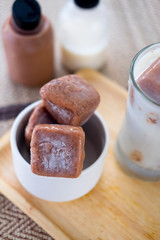 Chocolate ice cubes served with milk and coca bottle