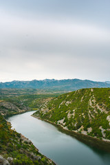 Obraz premium View of the beautiful clear Cetina river flowing through the mountains in the continental part of Croatia, Europe, in summer. 