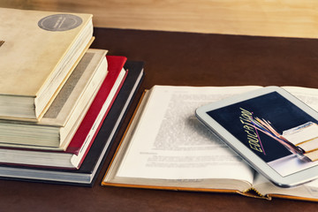 Open textbook and notepad on the table. The concept of intelligence comes from education and can...