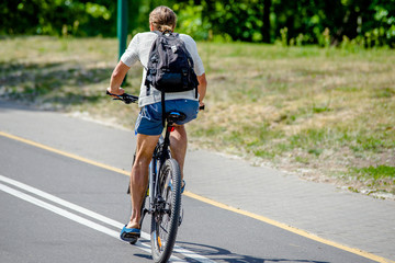 Fototapeta premium Cyclist ride on the bike path in the city Park 