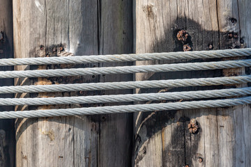 Rope tied around a wooden post at a harbor