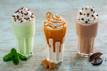 Tasty different milkshakes with ingredients