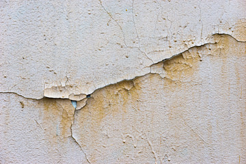 Texture of a stone wall with cracked paint