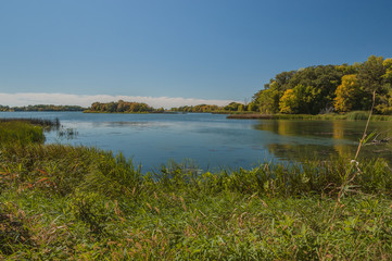 Peaceful late summer landscape of water and trees in Monson Lake State Park in Minnesota