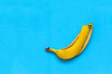 yellow skin of a banana against a blue background