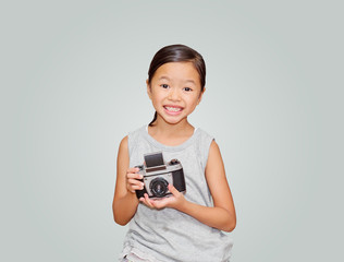 Beautiful smiling girl holding a camera.