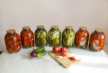 cans with pickled cucumbers, pickles and tomatoes, pickled, canned vegetables, onions, garlic, pepper
