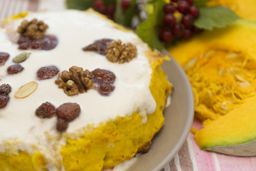 Pumpkin homemade cheesecake with white cream. Autumn still life. Thanksgiving day food.