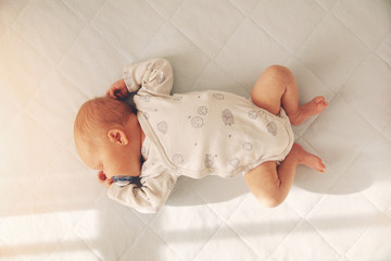 newborn baby boy sleeping in a cot. top view