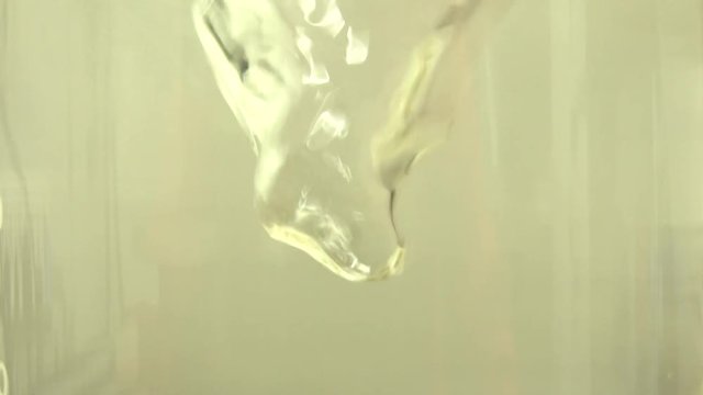 close up of fluid stirring in flask jar