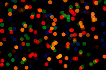 Colorful christmas bokeh isolated on black background. Christmas tree light background. New year decorations.