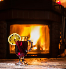 Hot mulled wine with orange slice, cloves and cinnamon stick.