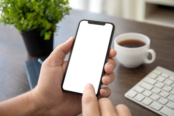 man hands holding phone with isolated screen in office