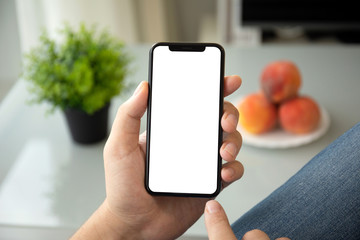 man hands holding phone with isolated screen in room house