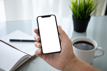 man hand holding phone with isolated screen in office