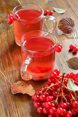 Red hot tea with viburnum berries in a glass cup