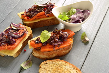 Bruschetta with roasted pumpkin, cheese and fried onions