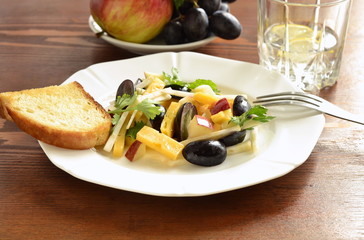 Cheese salad with grapes, apple and celery served with toasted bread