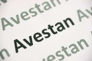 Fototapeta premium word Avestan language printed on paper macro