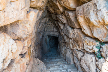 Entry to the tunnel of the large underground water cistern of the citadel of Mycenae. Archaeological site of Mycenae in Peloponnese Greece