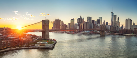 Panoramic view of Brooklyn bridge and Manhattan at sunset, New York City