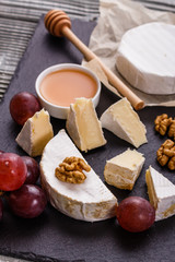 delicious creamy camembert cheese on a wooden rustic background