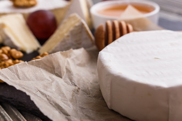 delicious creamy camembert cheese on a wooden rustic background