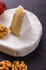 delicious creamy camembert cheese on a wooden rustic background