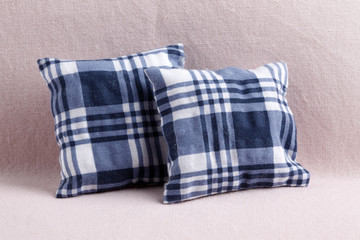 Close up of two checked  pillows on the sofa