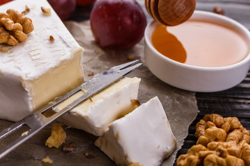 delicious creamy camembert cheese on a wooden rustic background