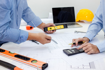 Architect and businessman meeting discuss a plan about the construction project of real estate.