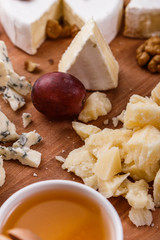 set of different cheeses on a wooden rustic background