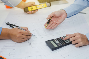 Architect and businessman meeting discuss a plan about the construction project of real estate.