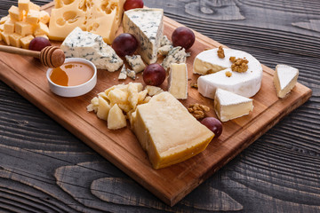 set of different cheeses on a wooden rustic background