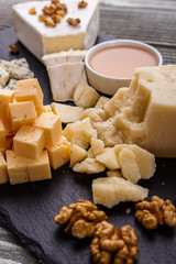 set of different cheeses on a wooden rustic background