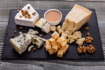 set of different cheeses on a wooden rustic background