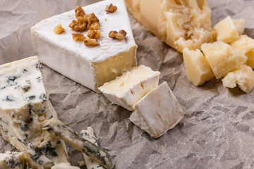 set of different cheeses on a wooden rustic background