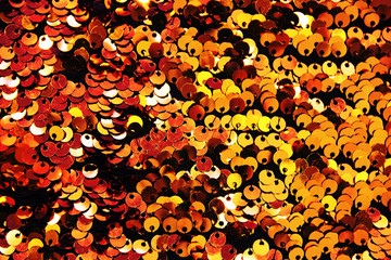 Gold sequins textile background close up. Round sequins texture.