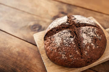 Fresh bread on wooden table.  Rye Bread on cutting board close up.