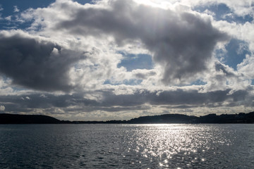 Dramatic cloudscape with sunlit sky over the Isles of Scilly on a sunny day
