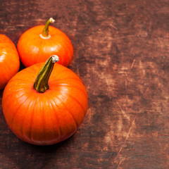 Orange pumpkins  on wooden table. Thanksgiving day or seasonal autumnal concept card.