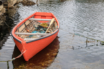 Little red dory fishing boat in water, Peggy's Cove.