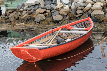 Obraz premium Little red dory fishing boat in water, Peggy's Cove.